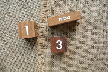 Friday 13th on wooden calendar. bad luck, Misfortune Day, Halloween Concept.