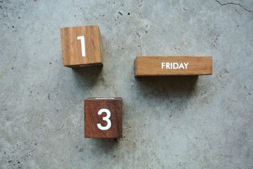 Friday 13th on wooden calendar. bad luck, Misfortune Day, Halloween Concept.
