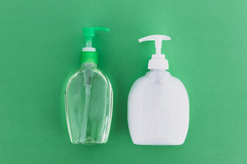 keep clean to fight bacteria and viruses, hand sanitizer and liquid soap and green background
