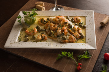 White fish fillet with shrimp sauce with capers