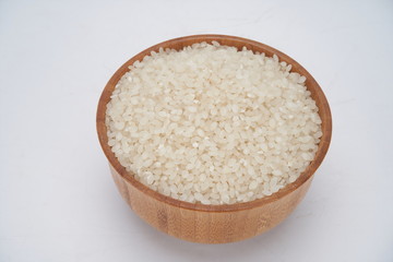 Rich and full rice in wooden bowl, retro style