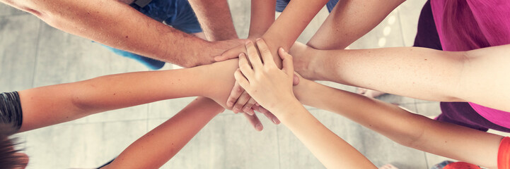 Group of people joining hands, success in teamwork, friends with hands together