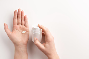 Women hands with container of cream isolated, on white background. Flat lay, top view, copy space. Organic cosmetic concept.