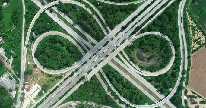 traffic on 4-way stop street intersection circle roundabout in bangkok, thailand. 4K UHD horizontal aerial view.