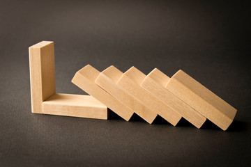 Playing dominoes on a dark background. Leisure games concept. Domino effect. Selective focus.