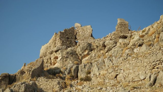 Low angle view of the ruins of Feraklos Castle against the blue sky, Rhodes, Greece