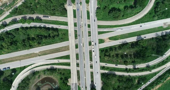 traffic on 4-way stop street intersection circle roundabout in bangkok, thailand. 4K UHD horizontal aerial view.