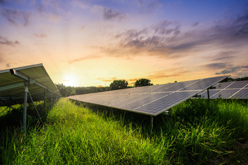 Solar panel cell on dramatic sunset sky background,clean Alternative power energy concept.