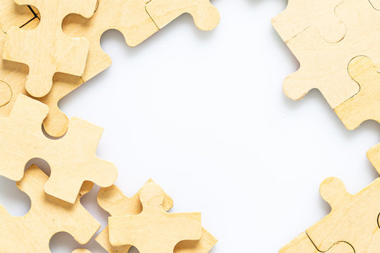 Wooden Jigsaw Puzzle Pieces On White Background