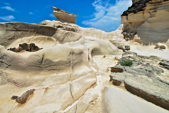 Scenic low-angle view of Capurpuraoan Rocks, also Kapurpurawan Rock Formation at the coast near Burgos, Ilocos Norte, North Luzon, Philippines, Asia