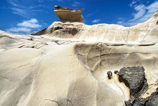 Scenic low-angle view of Capurpuraoan Rocks, also Kapurpurawan Rock Formation at the coast near Burgos, Ilocos Norte, North Luzon, Philippines, Asia