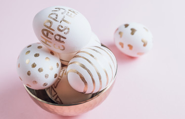 Easter eggs are hand-drawn on pink pastel background. Selective focus. Space for text. Minimalism and Happy Easter concept.