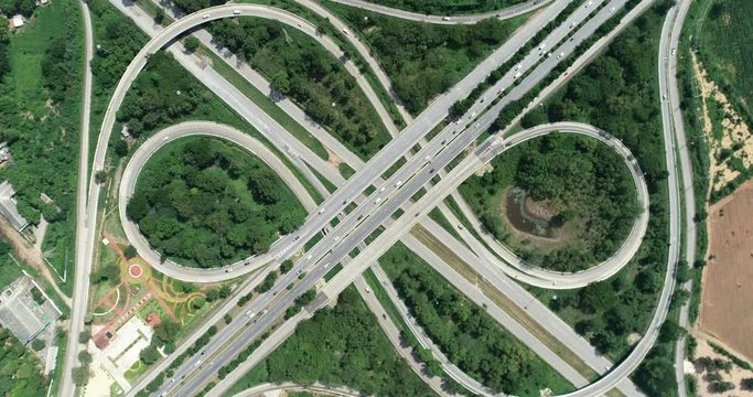 traffic on 4-way stop street intersection circle roundabout in bangkok, thailand. 4K UHD horizontal aerial view.