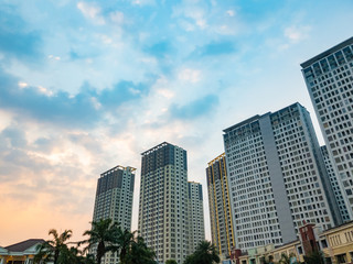 Fototapeta na wymiar Tangerang, Indonesia - July 2019: Luxury apartments M-Town Residence in Gading Serpong, Tangerang; photographed at sunset with beautiful sky. 