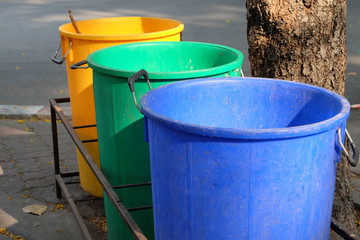 Naklejka premium Plastic bins are placed in the park so people can use the service, discard unused things and protect the environment.