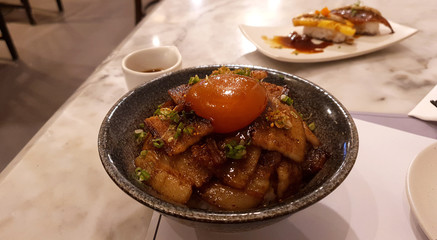 Roasted pork belly sliced with Japanese sauce with Soy sauce raw egg yolk on white rice