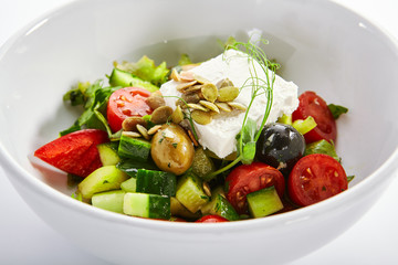 Greek salad in white bowl