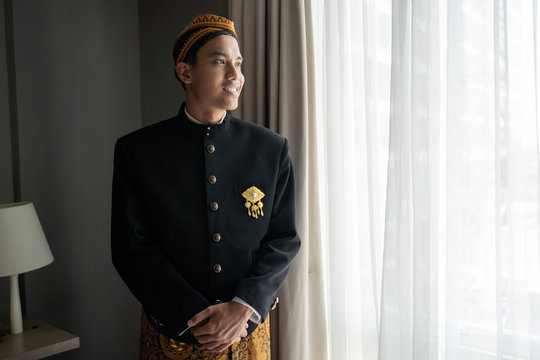 Young asian man wearing traditional clothes,beskap is traditional heritage clothes from Java,Indonesia