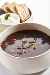 Borscht in bowl with roasted toasts and sour cream