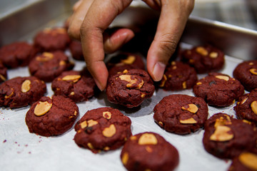 A hand hold a red velvet cookies