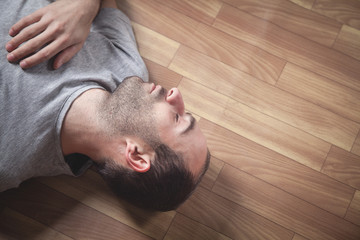 Caucasian unconscious man at home.