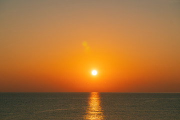 The sun rises on the sea at summer morning 