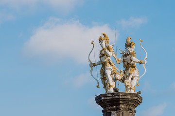 The statue of Nakula & Sadewa stands tall at a height of blue sky.