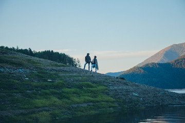 Obraz premium the concept of tourism, recreation, and travel - bursts of blue water in the river, mountains, and sky. A person travels. Copy space