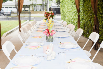 table holiday serving decoration on a patio easter idea with flower bouquet easter eggs rabbit with blue table cloth