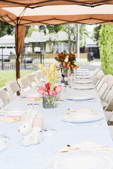 table holiday serving decoration on a patio easter idea with flower bouquet easter eggs rabbit with blue table cloth