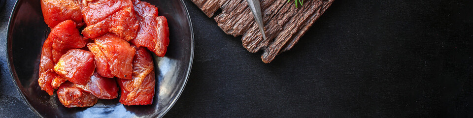 raw meat pork or beef in a plate on the table (preparing healthy food, marinade and spices paprika)...