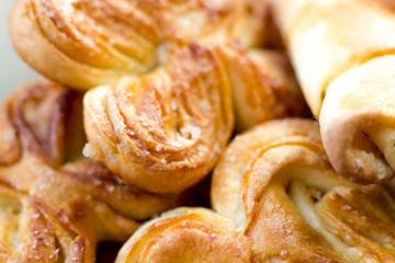 Spicy homemade cakes. Sugar rolls. Pastry background.
