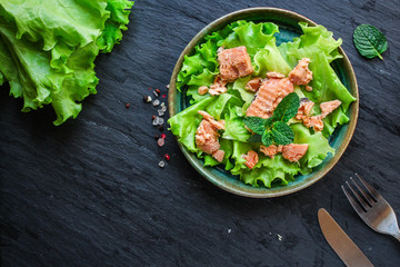 fish salad canned salmon or tuna (lettuce and other ingredients) menu concept background. top view. copy space for text