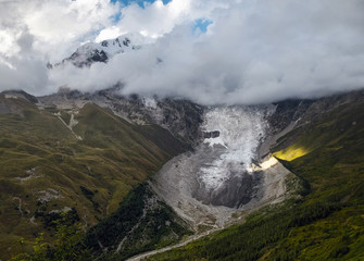 Aerial view to Adishi icefall and tongue with small waterfall on it moraine and kar, Tetnuldi mountain top in Svaneti Georgia