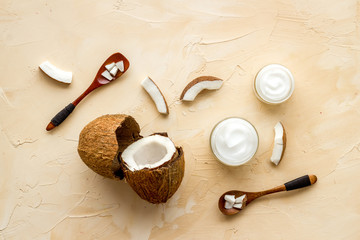 Fototapeta na wymiar Homemade coconut cream - still life with spoon - on beige background top-down