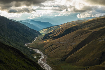 Scenic landscape with mountain river and small lake and blue mountains view from a top
