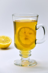 A slice of lemon stuck in a cup of tea