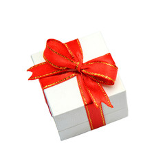 White gift box with red ribbons isolated on white background