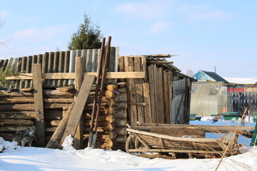 Wooden sled and dog on the background of a destroyed building