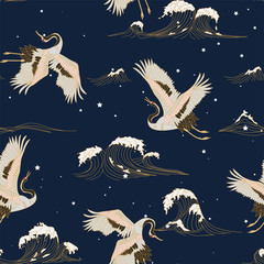 Obraz na płótnie Canvas seamless pattern with white japanese cranes on a background of night dark sky with stars and sea waves.