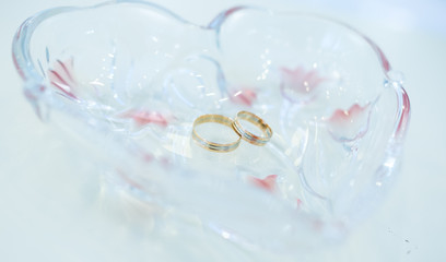  gold wedding rings on a crystal stand
