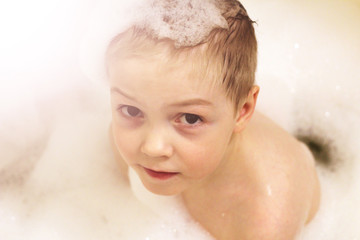 The boy in bath the filled foam