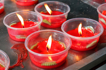 Burning Red Candle Bowls at the Chinese Shrine