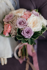 wedding bright bouquet of roses i pink ribbons on a purple background