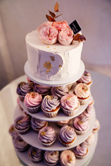  white holiday cake with pancakes and decorative accents