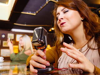 Woman singing with microphone