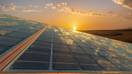 clean energy concept, photovoltaic panels in the light of the rising sun