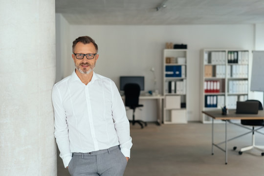 Relaxed successful businessman in spacious office