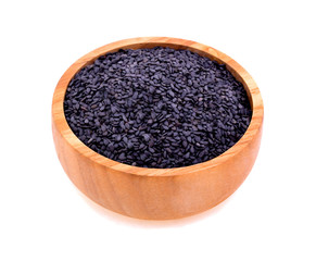 Black sesame in a wooden cup isolated on white background