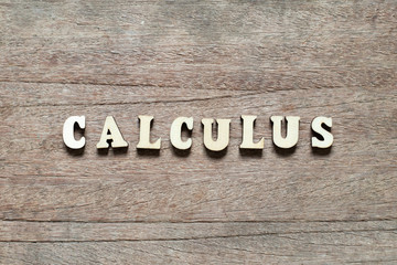 Letter block in word calculus on wood background